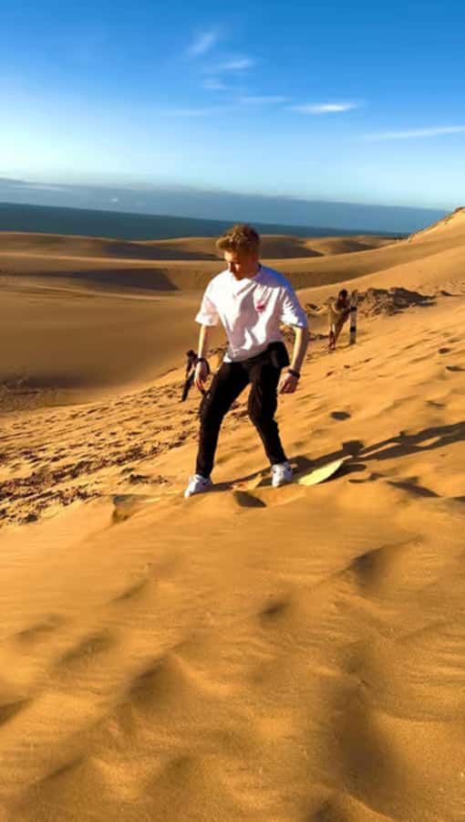 Best Agadir Desert Adventure: Quad Camel Sandboarding & BBQ - Sandboarding at Timlalin, from first try to sunset