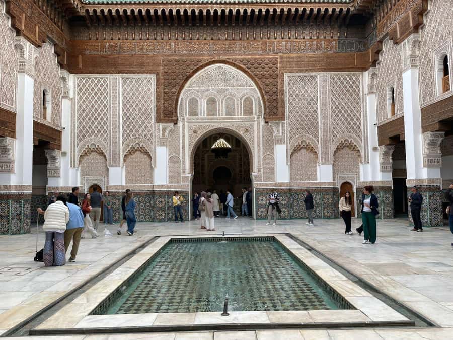 Marrakech: Madrasa Ben Youssef, Secret Garden & Medina Tour - Walking through the Medina beyond the main shopping lanes