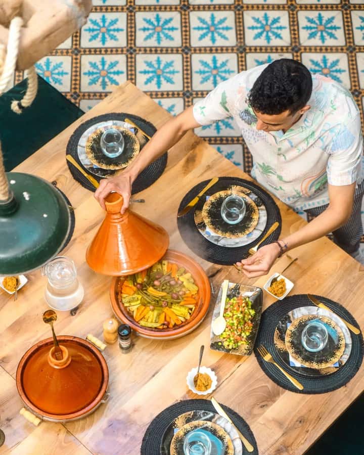 Moroccan Food Cooking Class with a Local Chef in Marrakech - Learning tagine techniques in the kitchen